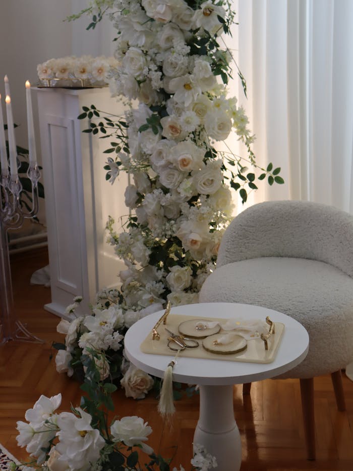 Luxurious white floral arrangement with tableware, perfect for weddings or elegant events.